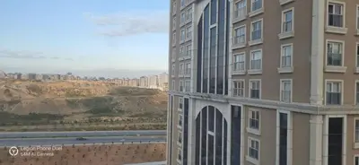 a view of a building with a mountain in the background at ميدوكليه بشاك شهير 1 in Istanbul