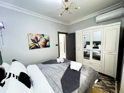 a bedroom with a large bed and a chandelier at Sisli Holiday 4412 in Istanbul