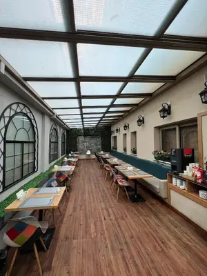 a cafeteria with tables and chairs in a building at Aybar Hotel & Spa in Istanbul