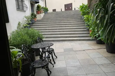 a patio with tables and chairs in front of stairs at The Print House Hotel in Istanbul