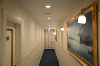 a hallway with a long hallway with a painting on the wall at Sarnic Hotel & Sarnic Premier Hotel(Ottoman Mansion) in Istanbul