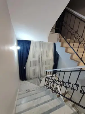 a staircase in a building with a blue curtain at Kilyos Serendipity in Sarıyer