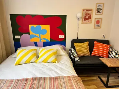 a bedroom with a bed with a couch and a painting at Central 5 Bedroom 5 Bathroom, Newly Renovated Villa at the heart of the city in Istanbul
