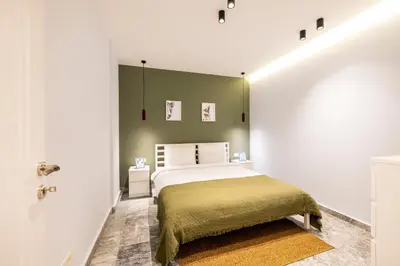 a bedroom with a bed and a green wall at Respiro Rooms in Istanbul