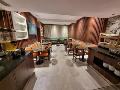 a restaurant with wooden walls and tables and chairs at RIJJI HOTEL ISTANBUL OLD CiTY in Istanbul