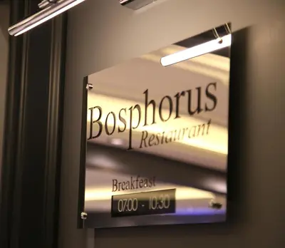 a sign for a boschius restaurant on a wall at Fimka Hotel in Istanbul