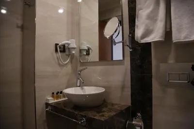 a bathroom with a sink and a mirror at Fimka Hotel in Istanbul