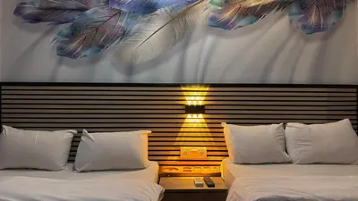 two beds with white pillows in a bedroom at Rozza Hotel in Istanbul