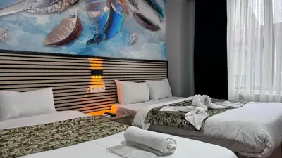 a bedroom with two beds and a painting on the wall at Rozza Hotel in Istanbul