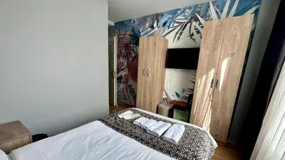 a bedroom with a bed and a painting on the wall at Rozza Hotel in Istanbul