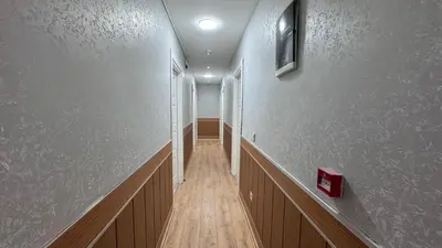 a hallway with white walls and a wooden floor at Rozza Hotel in Istanbul
