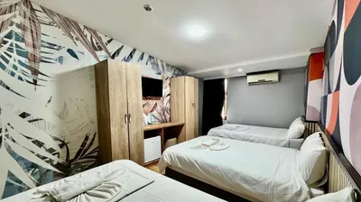 a small room with two beds and a desk at Rozza Hotel in Istanbul