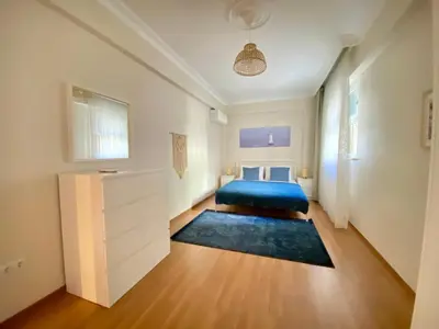 a bedroom with a blue bed in a white room at Spacious & City Center 3 Bedroom Flat - No2 in Istanbul