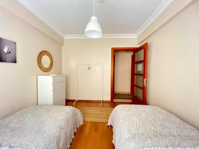 a bedroom with two beds and a red door at Spacious & City Center 3 Bedroom Flat - No2 in Istanbul
