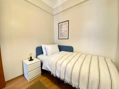 a small bedroom with a bed and a nightstand at Spacious & City Center 3 Bedroom Flat - No2 in Istanbul