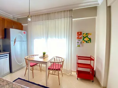 a kitchen with a table and chairs and a refrigerator at Spacious & City Center 3 Bedroom Flat - No2 in Istanbul