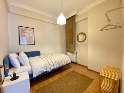 a bedroom with a bed and a table at Spacious & City Center 3 Bedroom Flat - No2 in Istanbul