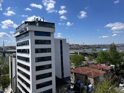 a white building with a sign on top of it at Astounding Sea View Apartment in Karaköy 4BR, 2BA in Istanbul
