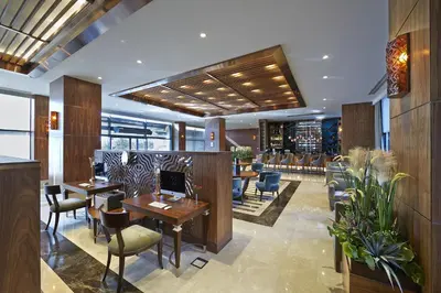 a restaurant with tables and chairs in a lobby at Uranus Istanbul Topkapi in Istanbul