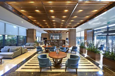a lobby with tables and chairs and windows at Uranus Istanbul Topkapi in Istanbul