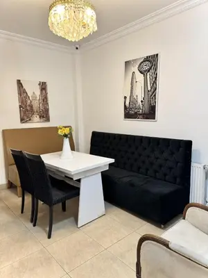 a living room with a black couch and a white table at Taksim Seven Residence in Istanbul