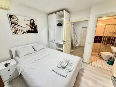 a bedroom with a white bed and a bathroom at Taksim Seven Residence in Istanbul