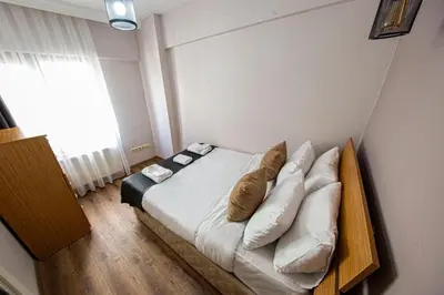 a bedroom with a bed with pillows on it at Three Apless süites in Istanbul