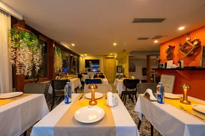 a restaurant with tables and chairs with white table cloth at Harmony Hotel Istanbul & SPA in Istanbul