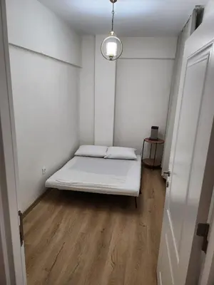 a small white room with a bed in it at KADIKOY merkezi konumda in Istanbul