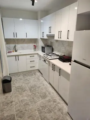 a kitchen with white cabinets and white appliances at KADIKOY merkezi konumda in Istanbul