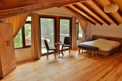 a bedroom with a bed and a table and chairs at Lal Hayal Konakları in Sapanca