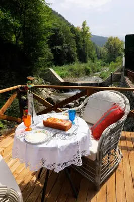 a table with a plate of food on a deck at Lal Hayal Konakları in Sapanca