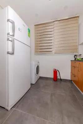 a kitchen with a refrigerator and a washing machine at Algold in Istanbul