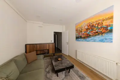 a living room with a couch and a painting on the wall at Algold in Istanbul