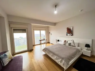 a bedroom with a bed and a large window at Luxury Unit with Sea View Taksim Square in Istanbul