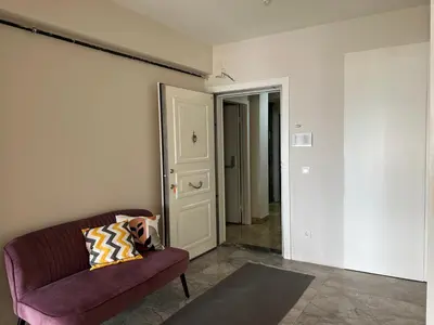 a living room with a purple couch and a door at Luxury Unit with Sea View Taksim Square in Istanbul