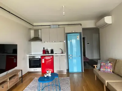 a living room with a couch and a red refrigerator at Luxury Unit with Sea View Taksim Square in Istanbul