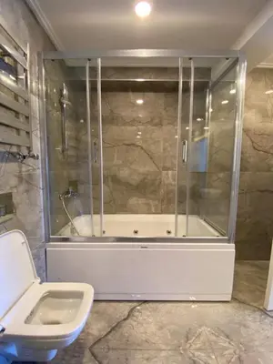 a bathroom with a shower and a tub and a toilet at Luxury Unit with Sea View Taksim Square in Istanbul