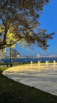 a parking lot with a view of the water at night at Istanbul Family Apartment in Istanbul