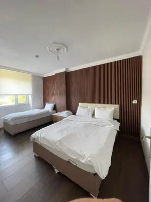 a hotel room with two beds and a window at Lina Apart in Arnavutköy