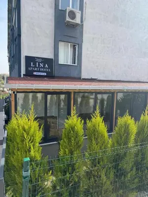 a building with a bunch of trees in front of it at Lina Apart in Arnavutköy