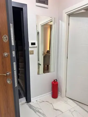 a red fire hydrant sitting in front of a door at ZARA'S HOME in Istanbul in Istanbul