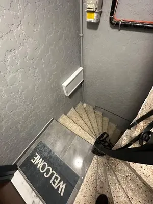 a spiral staircase in a room with a museum sign at ZARA'S HOME in Istanbul in Istanbul