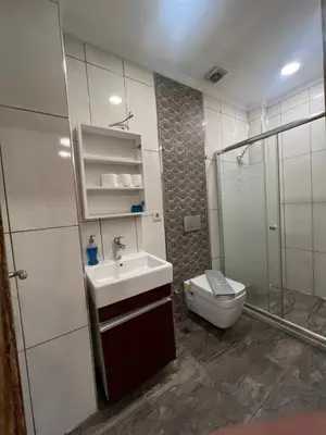 a bathroom with a toilet and a sink and a shower at KAMER Apart Hotel in Istanbul