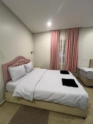 a bedroom with a large white bed and a window at KAMER Apart Hotel in Istanbul
