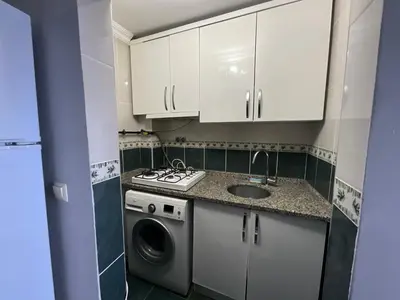 a small kitchen with a sink and a washing machine at KAMER Apart Hotel in Istanbul