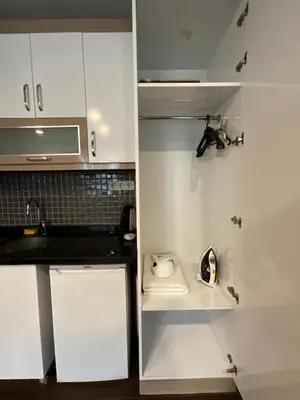 a small kitchen with white cabinets and a sink at KAMER Apart Hotel in Istanbul