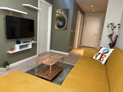 a living room with a couch and a tv at Take Me Home in Istanbul