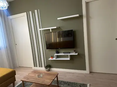 a living room with a flat screen tv on a wall at Take Me Home in Istanbul