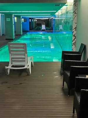 a swimming pool with a white chair in a building at Take Me Home in Istanbul